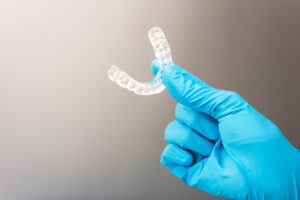 Dentist holds occlusal splint used to reduce nighttime bruxism.