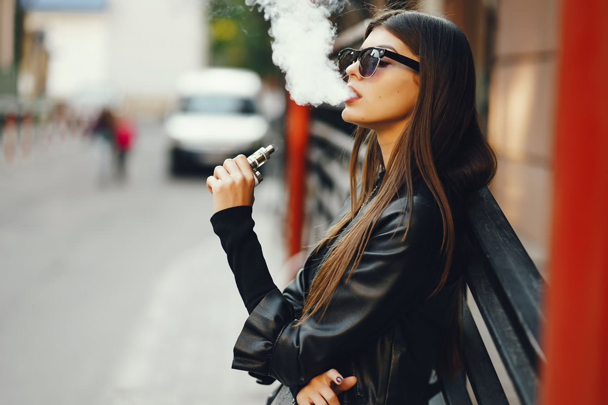 stylish girl smoking an e cigarette