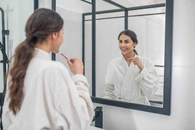 a young pretty woman in a white bathrobe brushing 2023 11 27 05 30 52 utc