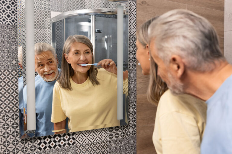 senior woman brushing teeth in the morning in a ba 2023 12 12 21 55 37 utc